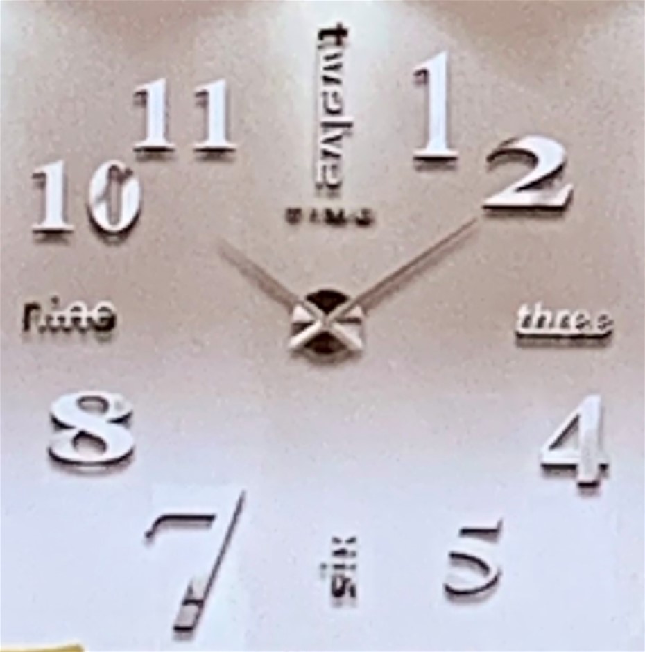 Small size stick on wall clock silver tone, varying size numbers