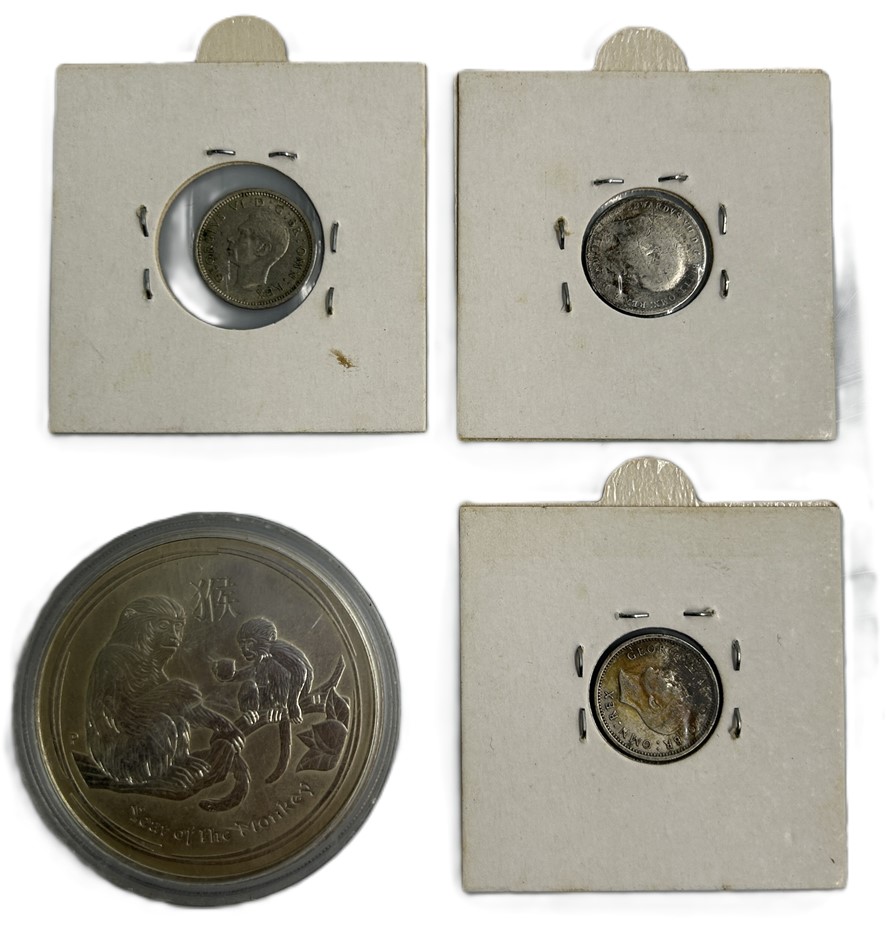 Set of four collectible silver coins including three British Threepence