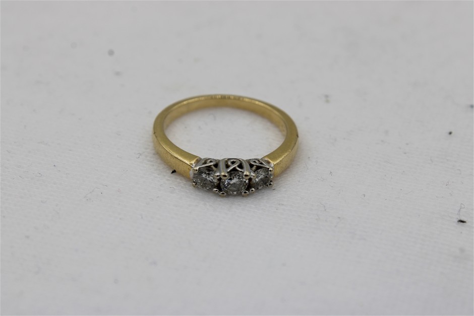 A Stamped 18ct Yellow and White Gold Claw Set Diamond Trilogy Ring