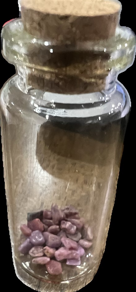 10 carat red ruby rough in glass vial