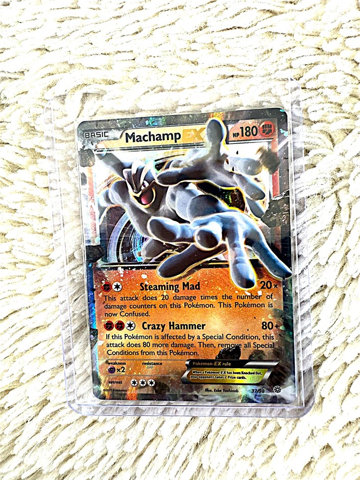 Machamp EX holographic fighting Pokémon card.
