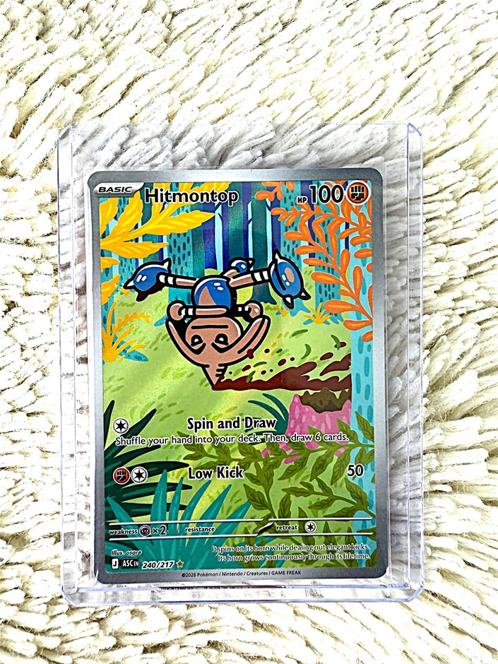 Hitmontop Illustration Rare card with colorful spinning pose.